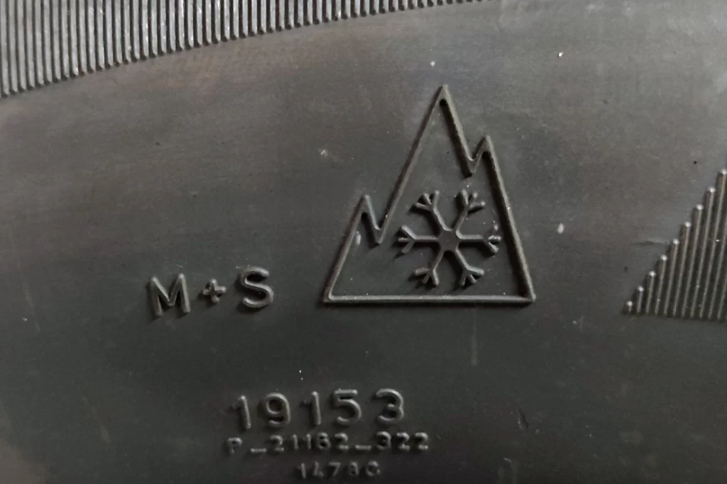 Close-up of a peak mountain snowflake symbol on a winter tire